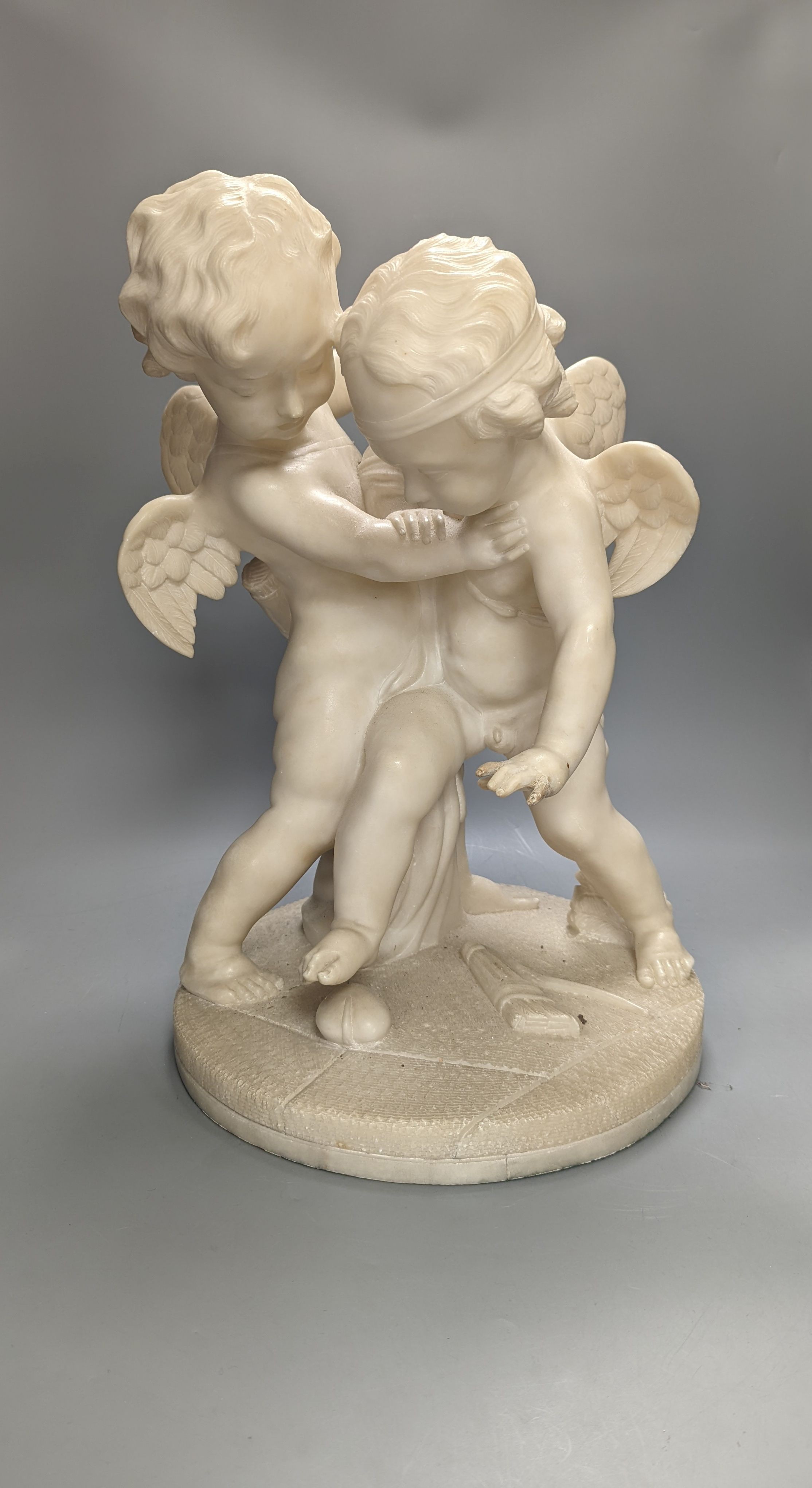 An early 20th century Italian carved alabaster cherub group, height 45cm